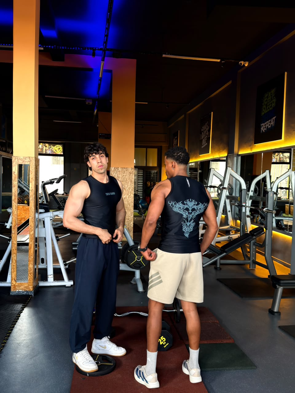 Men's Gym Tank Top worn in the gym, front and back prints